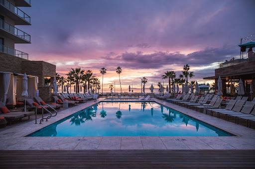 Hotel pool overlooking beach sunset